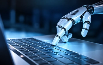 Illustrative robotic hand interacting with a laptop for integration development.
